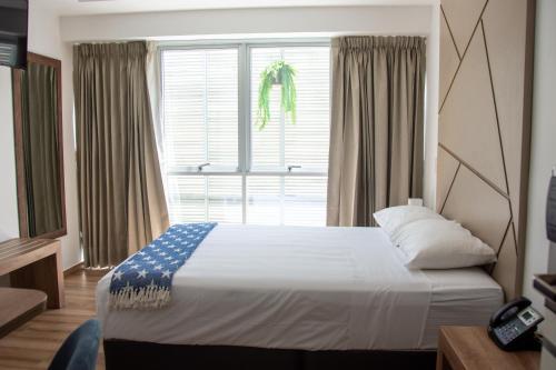 Un ou plusieurs lits dans un hébergement de l'établissement Grau Business Hotel