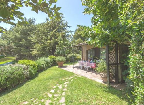 a garden with a table and a gazebo at Sweet tuscany Villa for 6 to 8 people near the sea in Capalbio