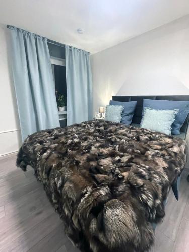 a bedroom with a large bed with a brown blanket at Metropolitan am Schloßpark in Paderborn