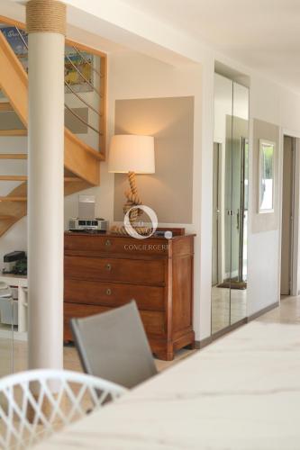 a living room with a dresser and a mirror at COC - Villa Parenthèse in Tardinghen
