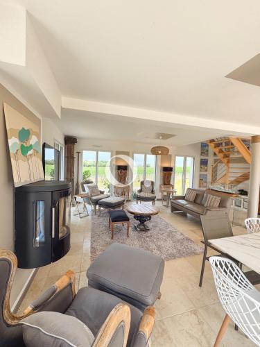 a living room filled with furniture and a fireplace at COC - Villa Parenthèse in Tardinghen
