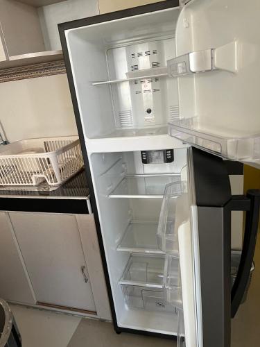 an empty refrigerator with its door open in a kitchen at Tu Espacio Exclusivo Privacidad y Comodidad in Tacna