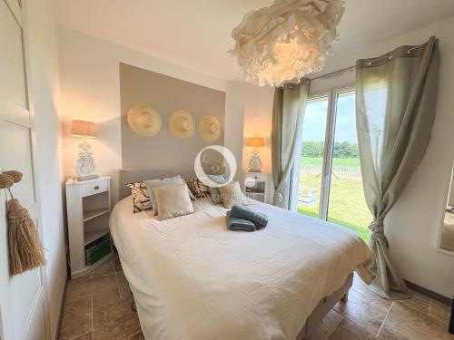 a bedroom with a bed and a large window at COC - Villa Parenthèse in Tardinghen