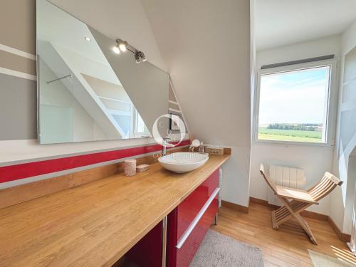 a bathroom with a sink and a mirror at COC - Villa Parenthèse in Tardinghen
