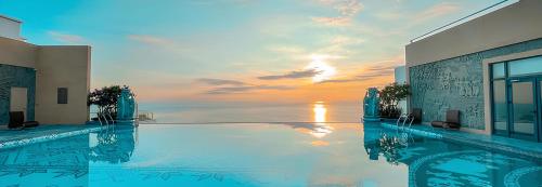 a swimming pool with a view of the ocean at Cozy Tranquility Mandala Retreat in Phan Thiet