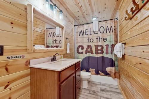 a bathroom with a sink and a toilet at Southern Comfort Cabin By Avada Properties in Gatlinburg