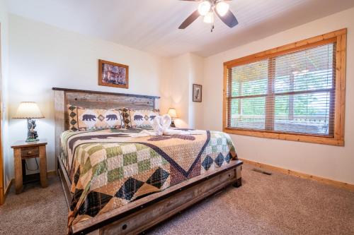 a bedroom with a bed and a ceiling fan at Starry Night Retreat By Avada Properties in Sevierville