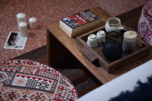 a table with a book and a table with a playing table sidx sidx at Peking Yard Boutique Hotel in Beijing