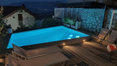 a swimming pool with lights on a deck at night at Villa Walter in Sorrento