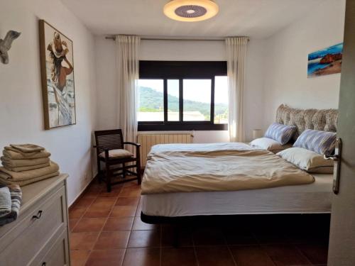 a bedroom with a bed and a couch and a window at Villa de Gracia Casa 2 in Tordera