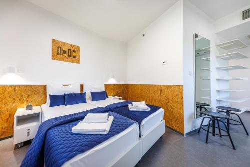 a bedroom with a blue and white bed and a mirror at Akademis Academia in Dubrovnik