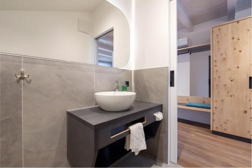 a bathroom with a sink and a mirror at Passerblick in Tirolo
