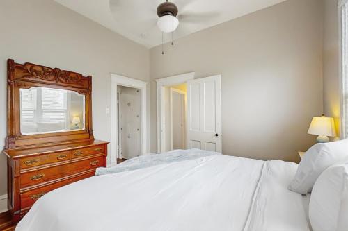 a bedroom with a bed and a dresser and a mirror at The Rogers Roost in Rogers