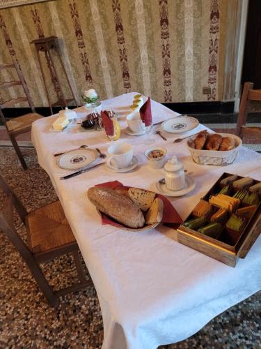 a white table with bread and other food on it at Château St Sulpice Chambre Porcelaine in Condal