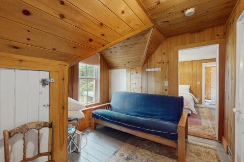 a blue couch in a room with a bedroom at Beach House in Oak Bluffs