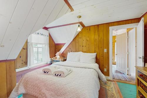 a bedroom with a large bed in a attic at Beach House in Oak Bluffs