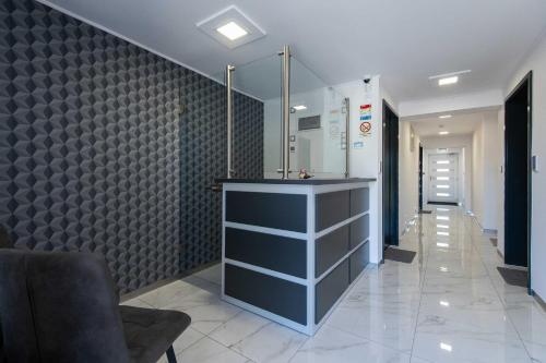 a hallway with a counter and a wall at Theresa Vendégház in Kiskunmajsa