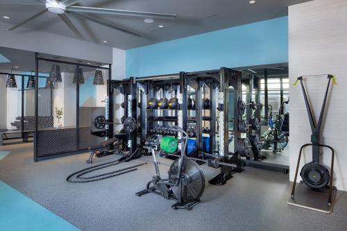 a gym with several bikes and exercise equipment in a room at Fun & Comfort Await: Apartment at Alexandria in Alexandria