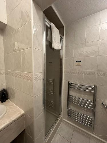 a bathroom with a shower and a sink at Guisachan Guesthouse in Fort William