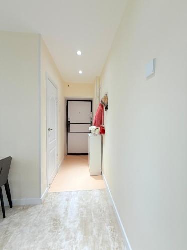 a hallway with a refrigerator in a house at Modern 2BR Next to Dept Store in Ulaanbaatar