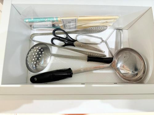 a drawer full of kitchen utensils in a refrigerator at Modern 2BR Next to Dept Store in Ulaanbaatar