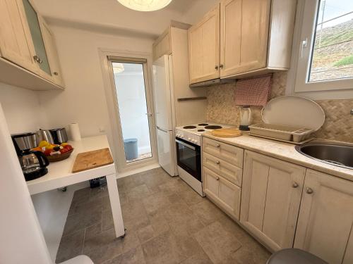 a kitchen with a sink and a stove top oven at Betty'appartment Mykonos in Panormos Mykonos