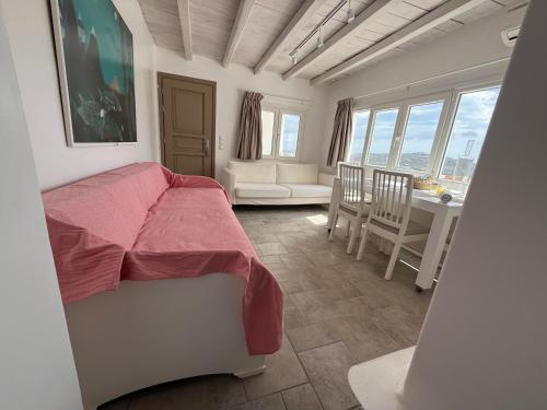 a bedroom with a bed and a table and chairs at Betty'appartment Mykonos in Panormos Mykonos