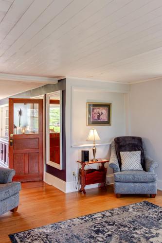 a living room with two chairs and a table at Westlake Cottages - Highway House in Wellington