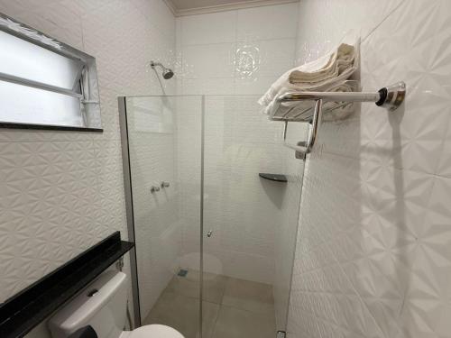 a bathroom with a shower with a glass door at Hotel Santa Catarina in Três Lagoas