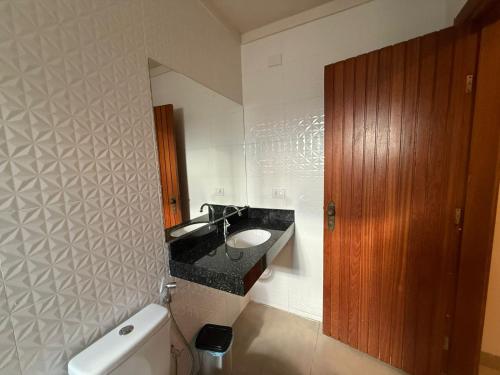 a bathroom with a sink and a toilet at Hotel Santa Catarina in Três Lagoas