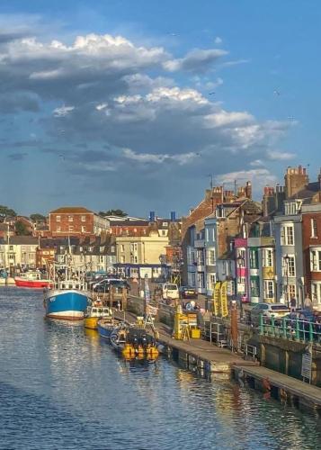 a group of boats are docked in a harbor at Great Georges Retreat Central Weymouth Beach Contactless Smart Accommodation in Weymouth