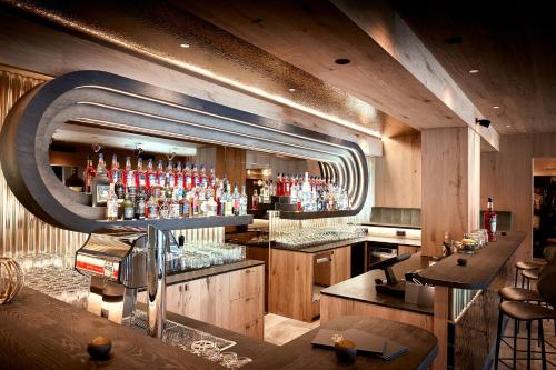 a bar with a lot of bottles of alcohol at Hotel Alte Post in Fieberbrunn