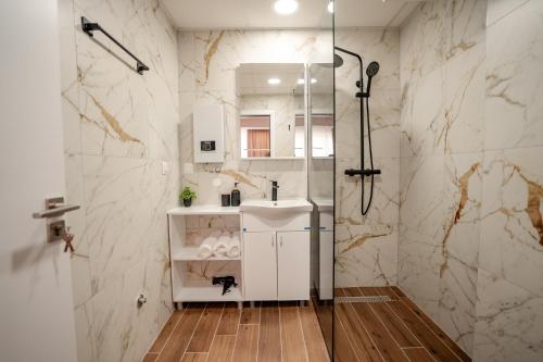 a white bathroom with a shower and a sink at Luxury Apartments Stefano - Prestige in Ohrid
