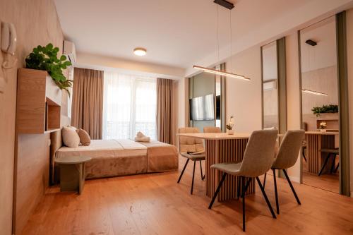 a bedroom with a bed and a table and chairs at Luxury Apartments Stefano - Prestige in Ohrid