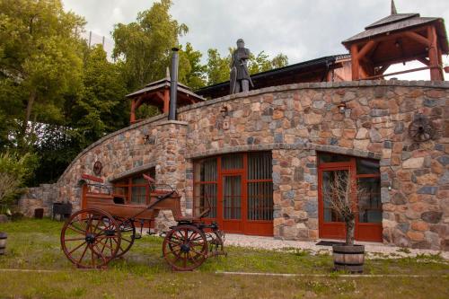 a stone building with a statue on top of it at Zámeček Kaliště in Poddubí