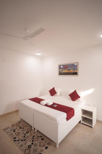 a white bedroom with a bed and a rug at Hotel Airport Stay in New Delhi