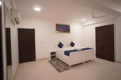 a bedroom with a bed and a painting on the wall at Hotel Airport Stay in New Delhi