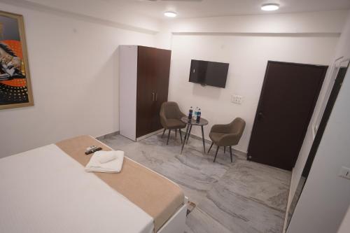 a room with two chairs and a table in it at Hotel Airport Stay in New Delhi