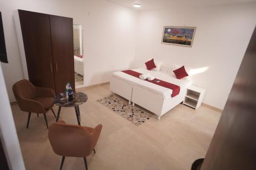 a bedroom with a white bed and a table and chairs at Hotel Airport Stay in New Delhi