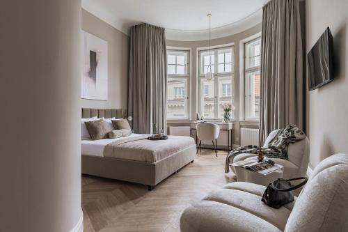 a bedroom with a bed and a living room at La Belle Epoque - LoftAffair Collection in Warsaw
