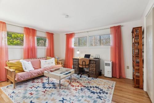 a living room with a pink couch and a desk at Washington's Rye House AC Bikes New Kitchen in Rye
