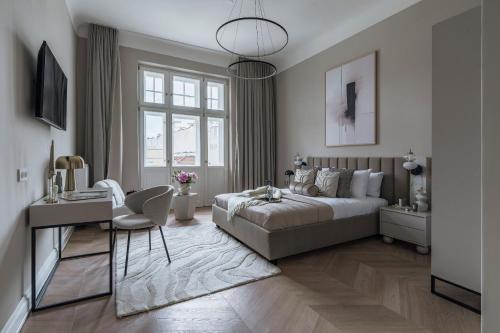 a bedroom with a bed and a desk and a chair at La Belle Epoque in Warsaw