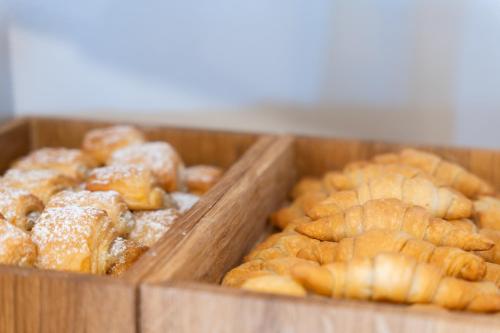 two wooden trays filled with pastries in a bakery at Barceló Marine Boa Vista - Adults Only in Sal Rei