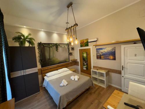 a bedroom with a bed with two towels on it at Dimora Elizabeth in Modugno