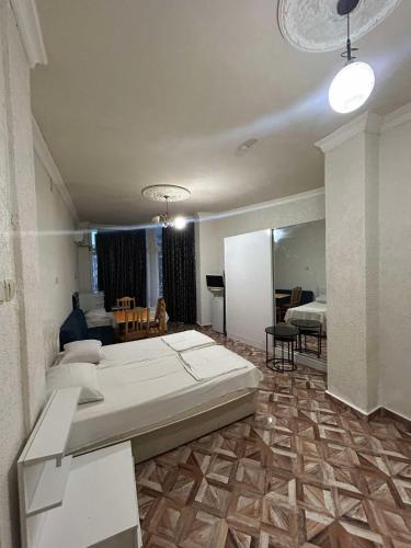 a bedroom with a large bed and a living room at Family hotel Khomaldy in Kvariati