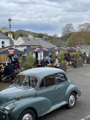 an old blue car parked in a parking lot at The Inverkip Restaurant, Bar & Hotel in Inverkip