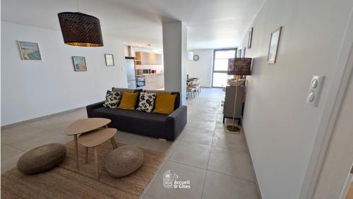 a living room with a couch and a table at La Petite Vue, Logement Climatis in Rouffach
