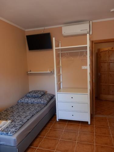 a bedroom with a bunk bed and a tv at Karpatia Esztergom in Esztergom