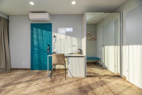 a kitchen with a table and a chair in a room at SPA Nida in Nida
