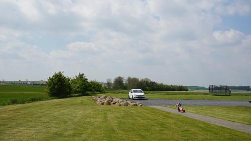 a van driving down a road with a herd of sheep at Kerteminde Byferie - Hyrdevej 83, 85B in Kerteminde